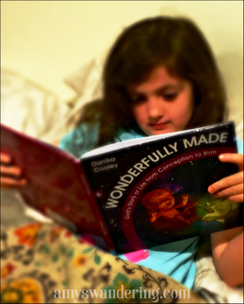 Amy's Daughter of Amy's Wanderings with their copy of Wonderfully Made: God's Story of Life from Conception to Birth for kids from ages 5-11.